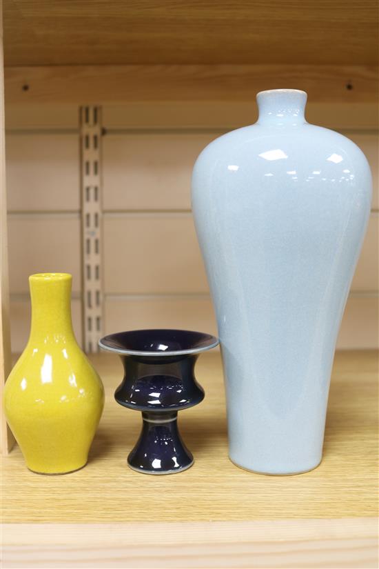 A Chinese blue-glazed stem cup, a yellow vase and a claire de lune glazed meiping